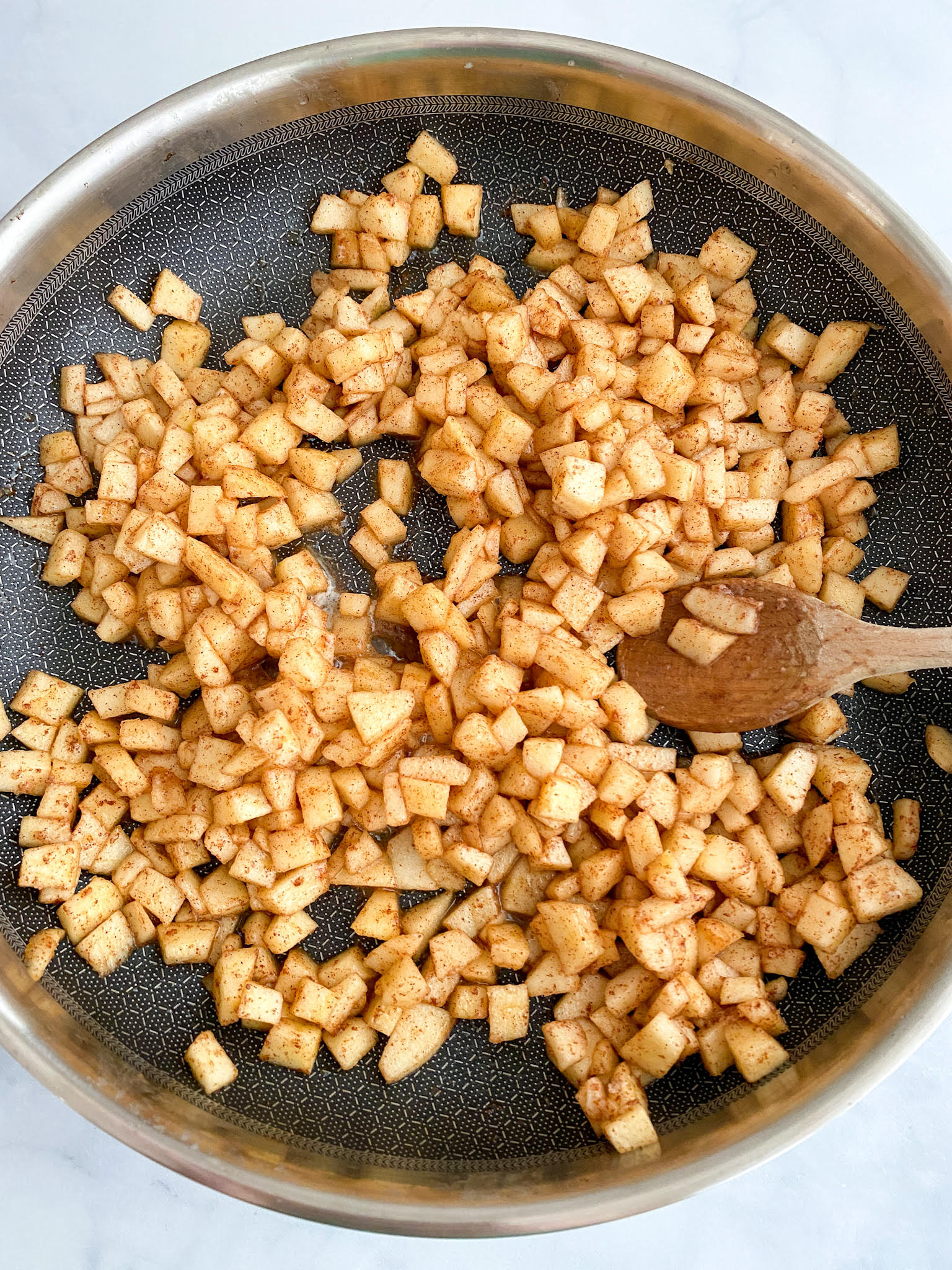 Cooking the apple mixture for apple fritter monkey bread