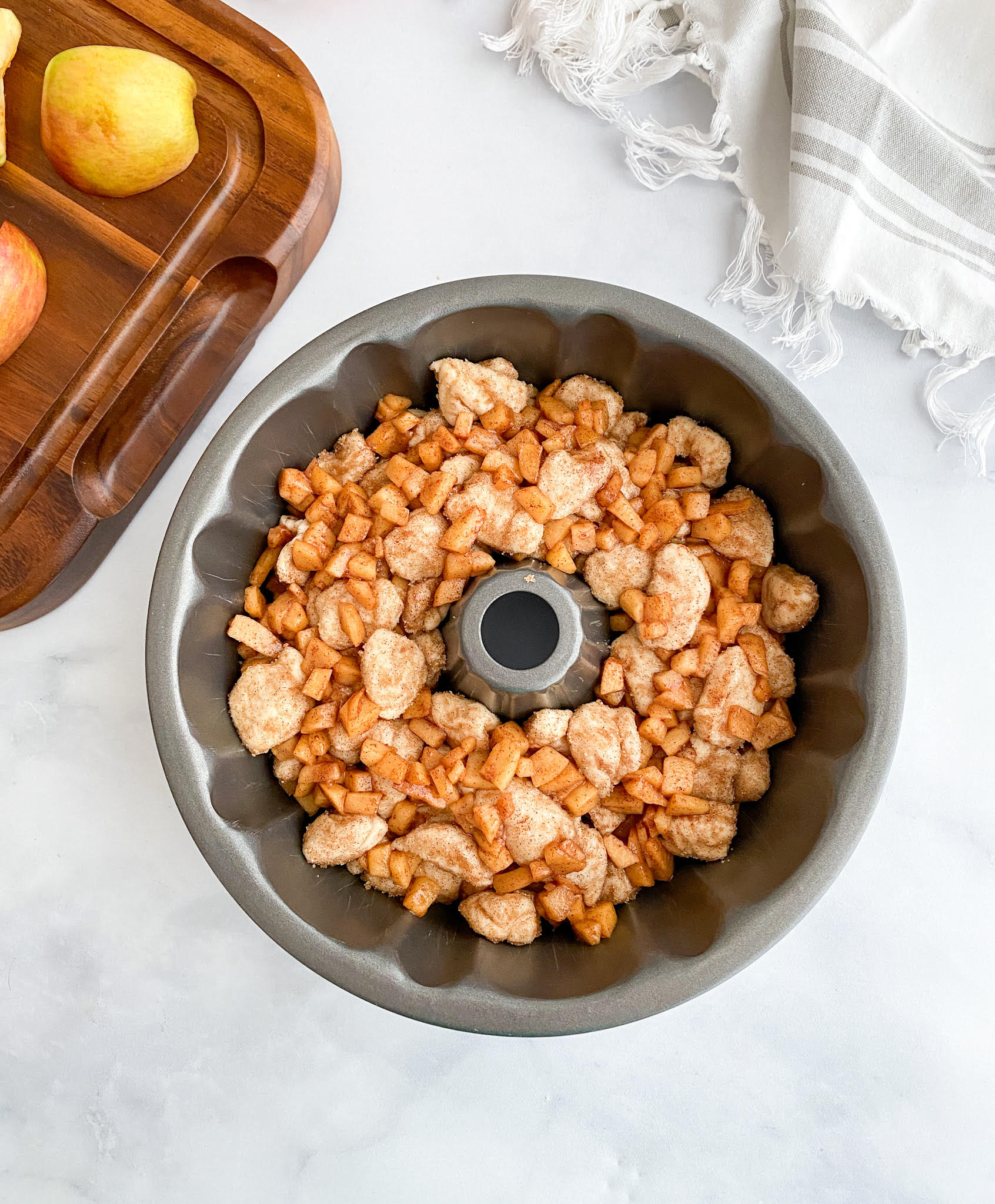 Layering the Apple Fritter Monkey Bread in the bundt pan