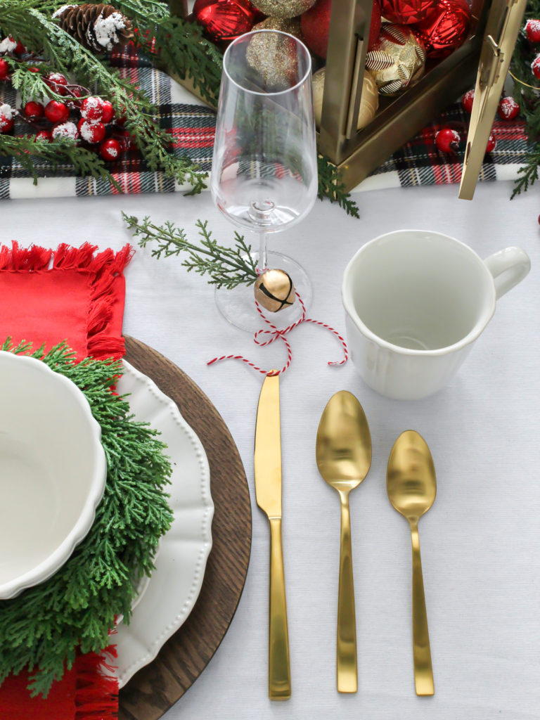 Simple and Festive Christmas Centerpiece Ideas  - Traditional Red and White Christmas Tablescape with Plaid and Gold Accents with Jingle Bells and Garland