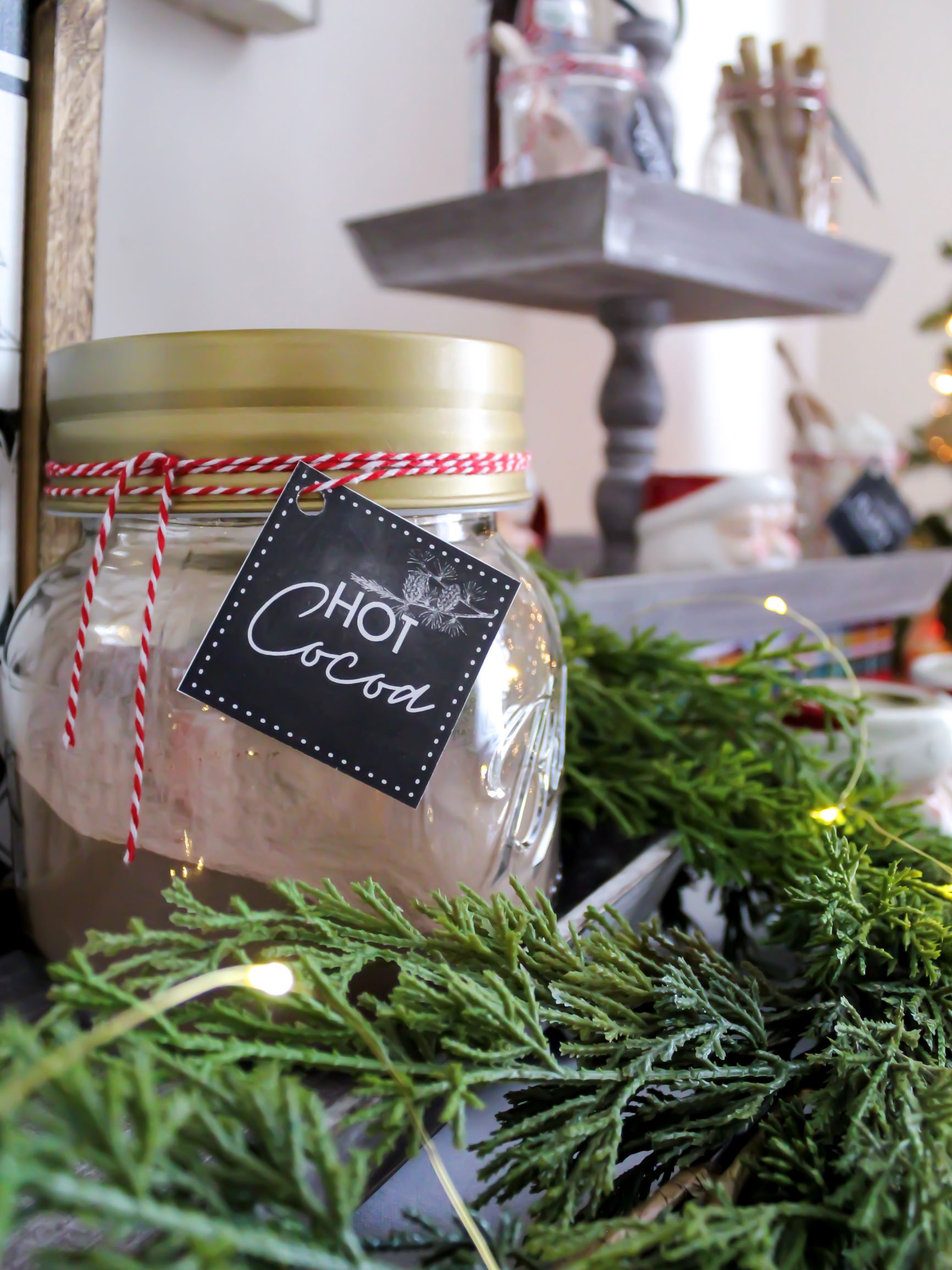 Dry hot chocolate mix in a glass container set up on a hot cocoa bar for the holidays