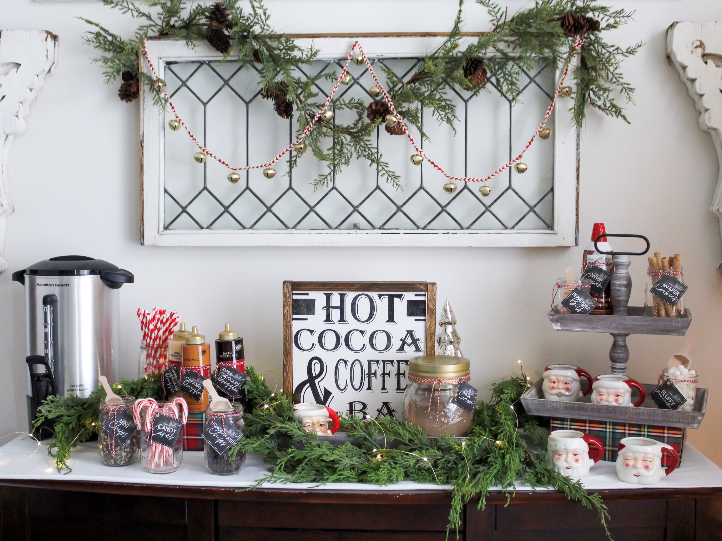 Cozy hot cocoa bar with all the toppings and with free printable tags set up on a buffet