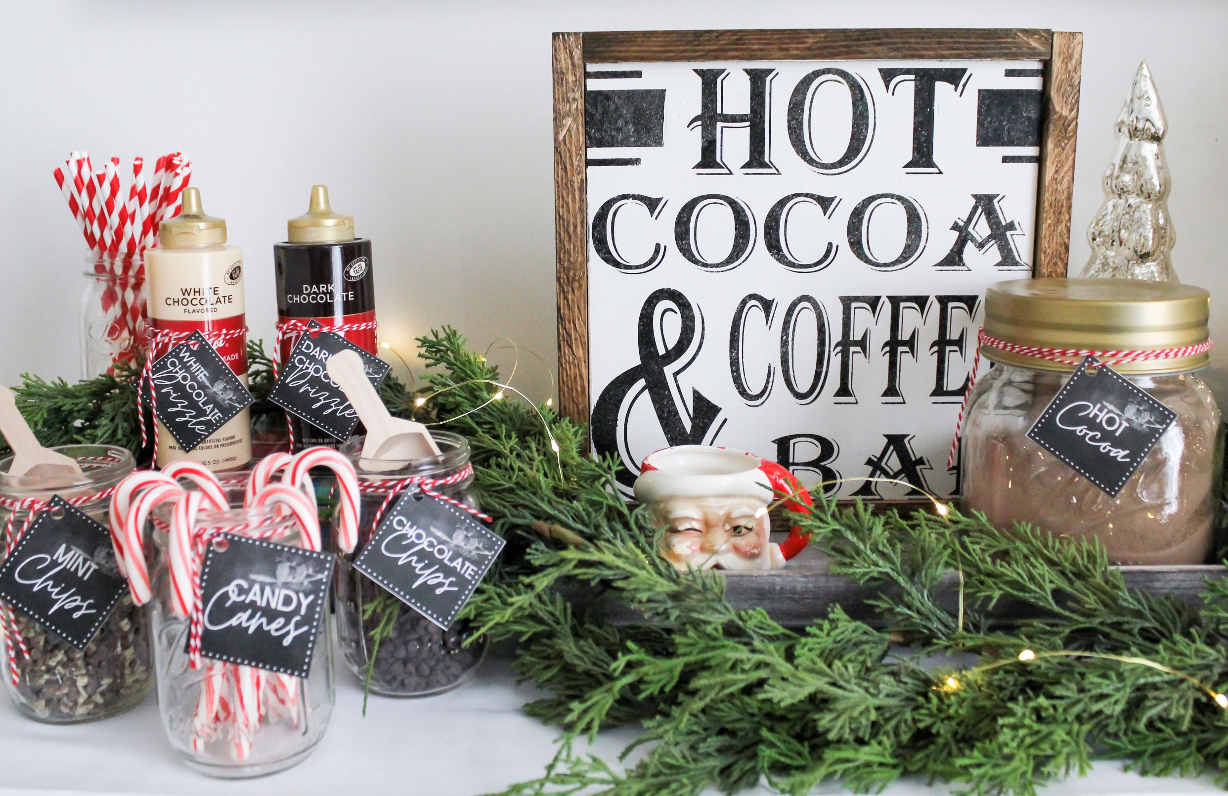 Hot chocolate bar toppings in pint mason jars and chocolate sauce and hot cocoa mix for a holiday hot cocoa bar