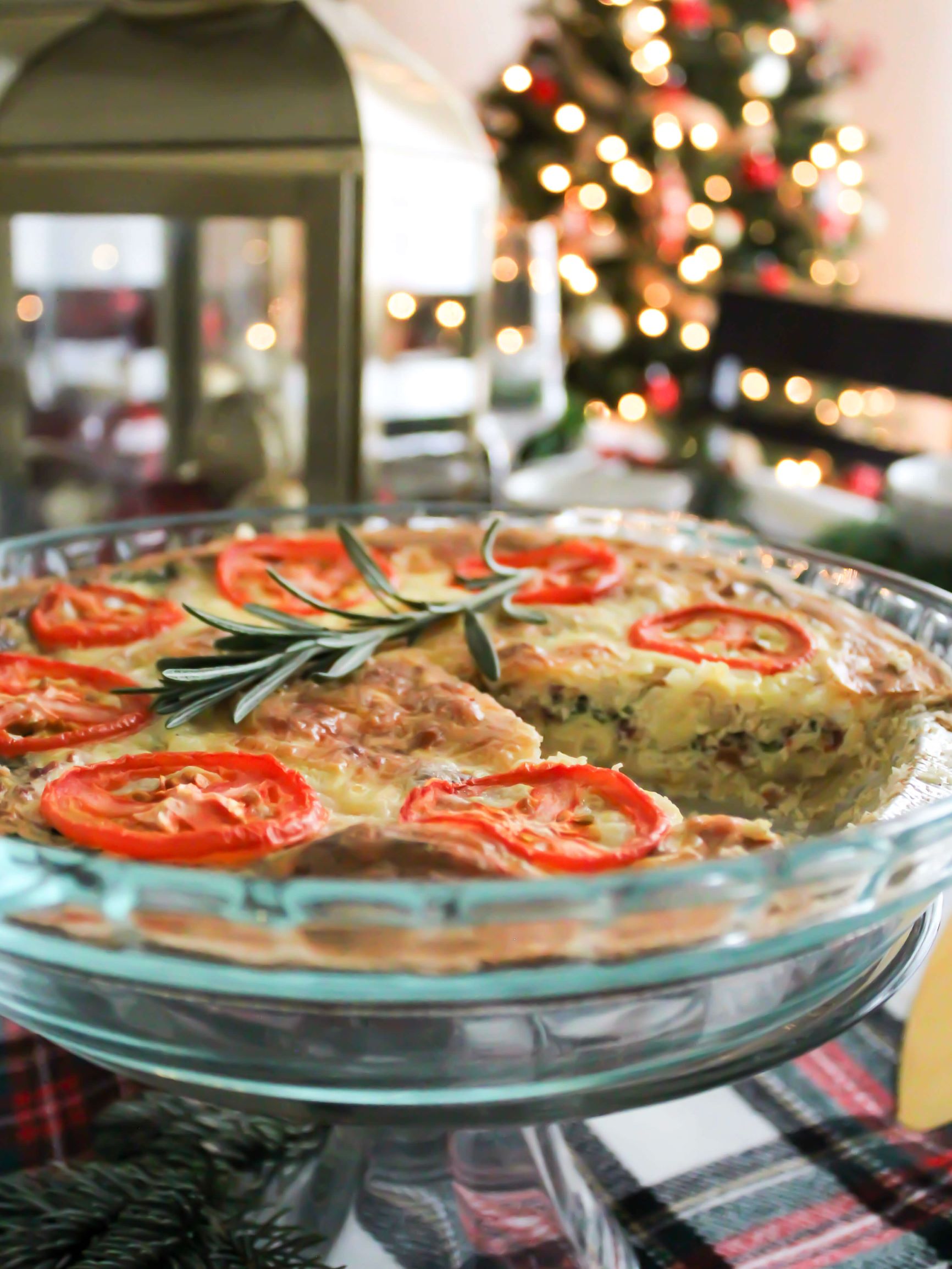 Finished Christmas Quiche filled with bacon and spinach set on the table