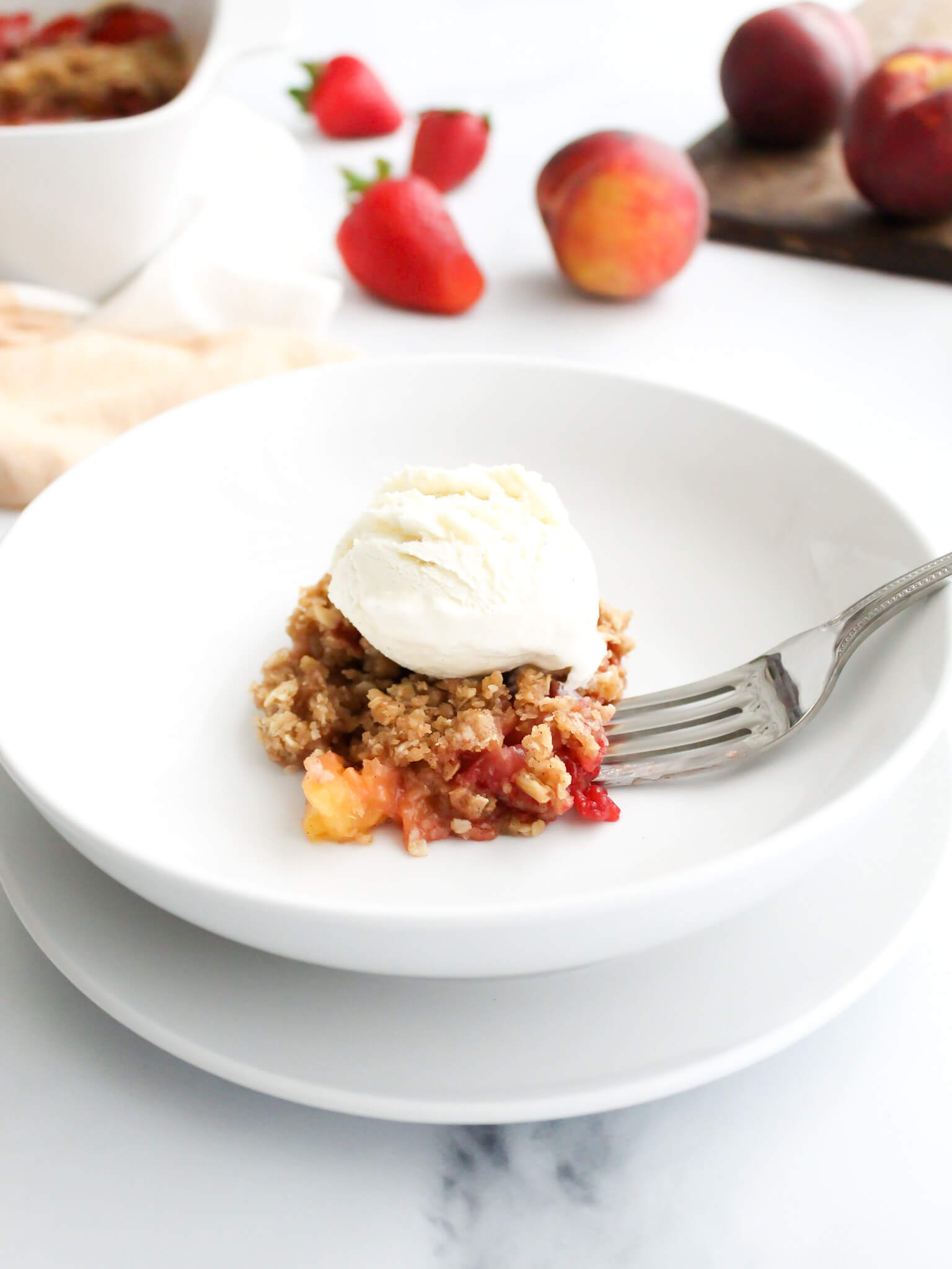 Old Fashioned Strawberry Peach Crisp Topped with Vanilla Ice Cream