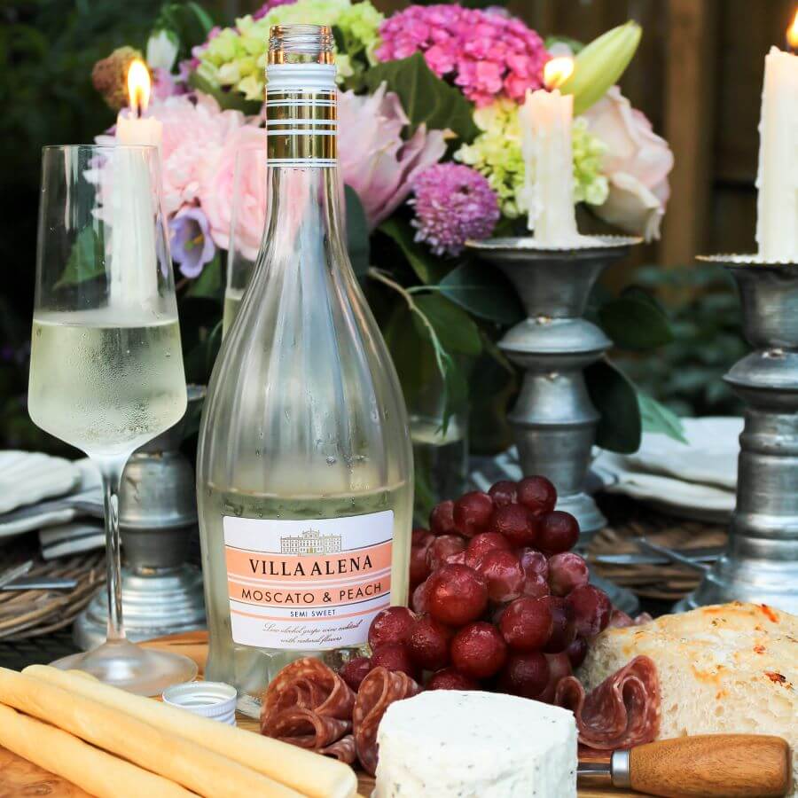 Date night in outdoor picnic charcuterie board with wine, grapes, cheese, and bread - Midwest Life and Style Blog