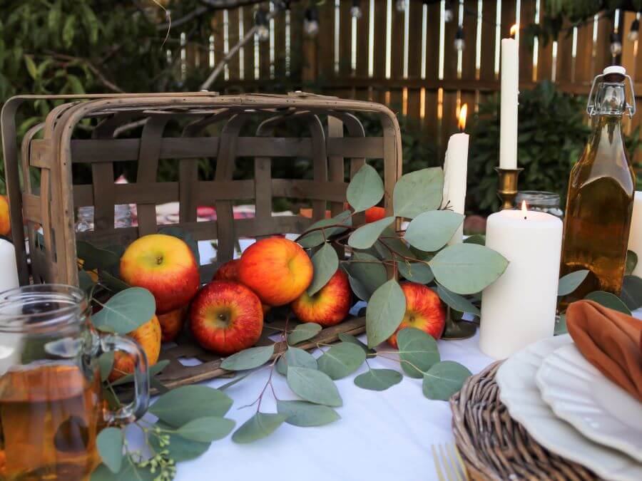 Basket of Fall Apples with Brass Candlesticks for Boho Pincic Tablescape - Midwest Life and Style Blog