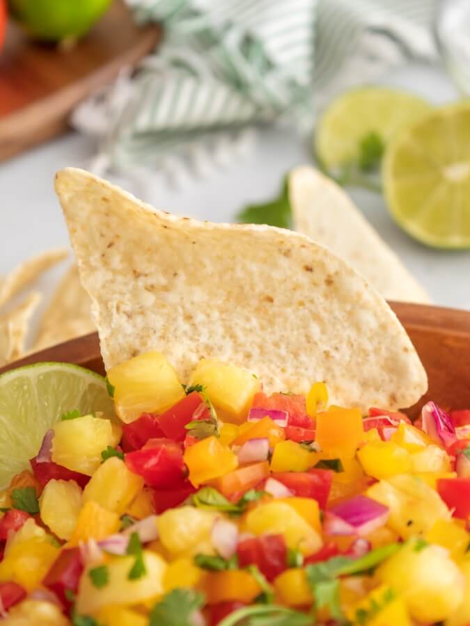 Easy Pineapple Jalapeño Salsa with a tortilla chip dipped in