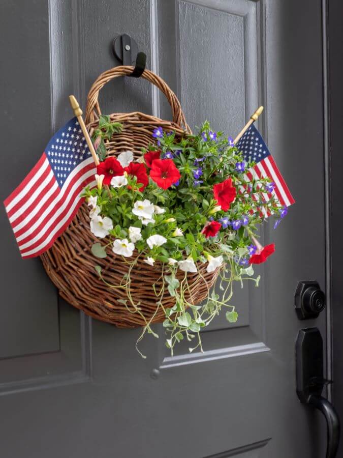 Side View of a Hanging Door Basket with Red, White and Blue Summer Flower and American Flags for the 4th of July