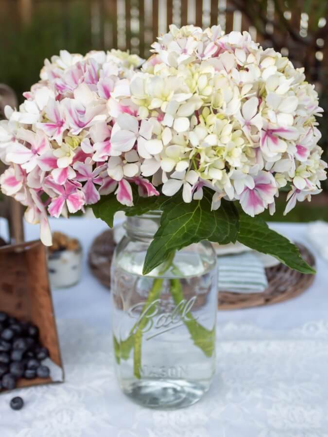 Hydrangea Bouquet in a Ball Jar on Oudoor Picnic Table - Midwest Life and Style Blog