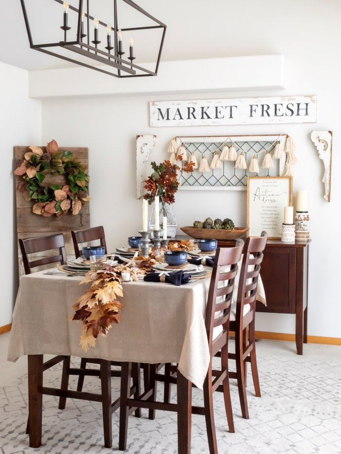 Fall tablescape with coastal decor and blue accents styled in a dining room decorated for fall