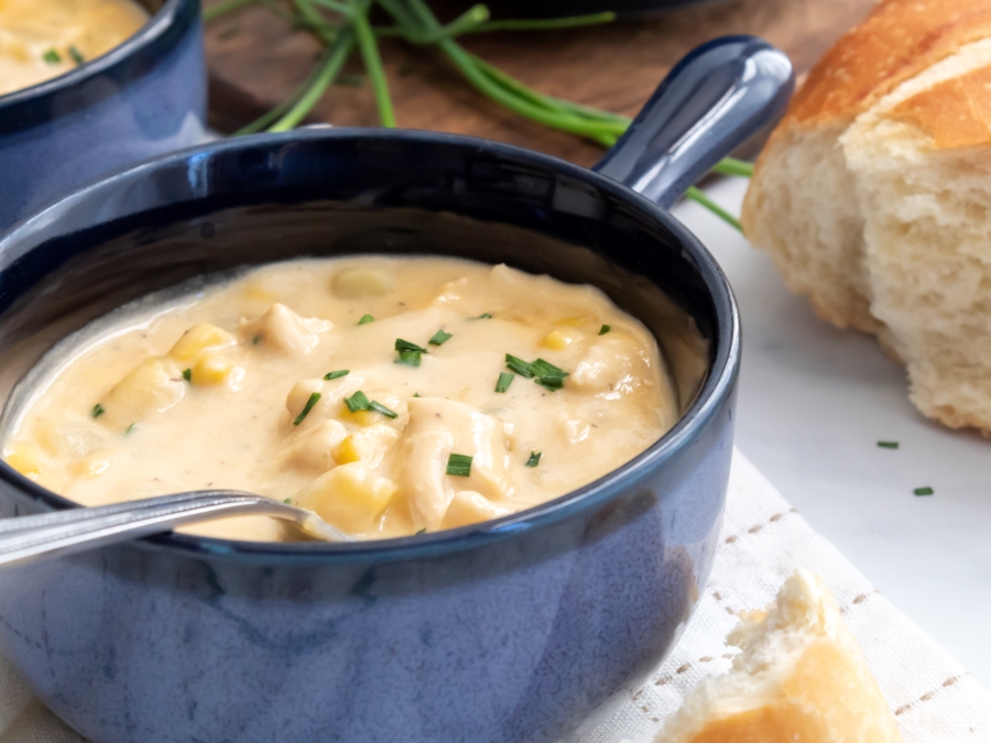 2 bowls of Creamy Chicken and Corn Chowder with a side of french bread