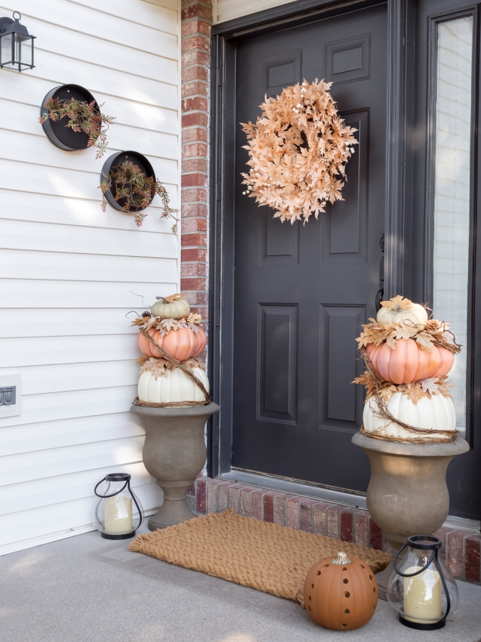 DIY Faux Stacked Pumpkin Topiaries Displayed in Urns on a Front Porch for Fall