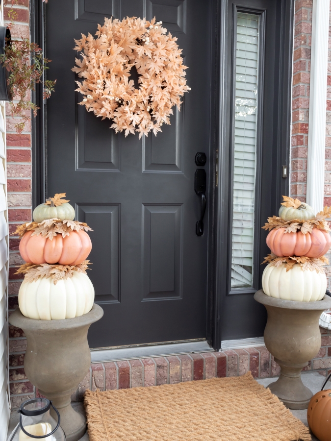 DIY stacked pumpkin topiaries displayed on a front porch for fall 