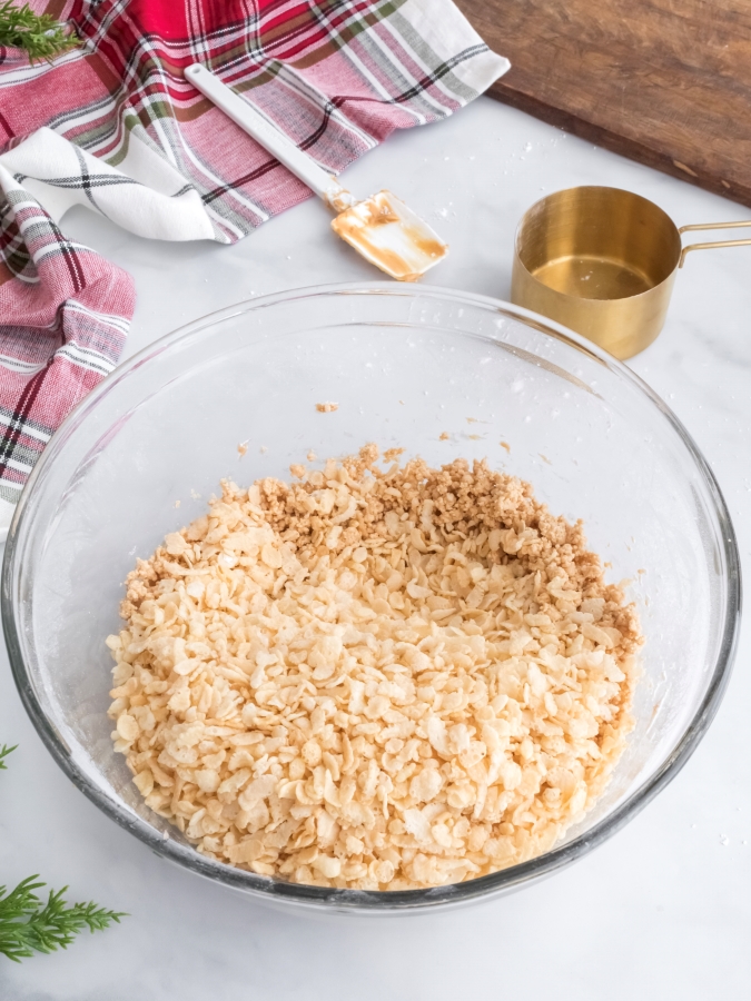 Peanut Butter Ball Ingredients in a mixing bowl with the Rice Krispies added