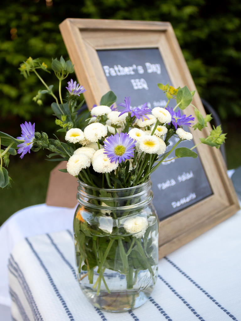 Close-up of Blue and Whtie Wildflowers In a Ball Jar for Backyard Father's Day BBQ Table - Midwest Life and Style Blog