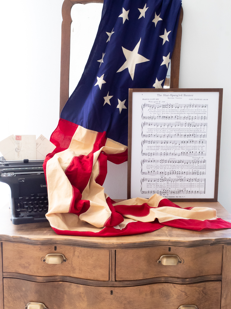 Vintage dresser with old typewriter, American flag and framed star spangled banner lyrics artwork - Red White And Blue Summer Home Tour - Midwest Life and Style Blog