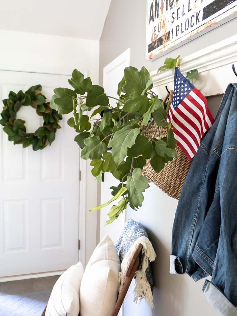 Patriotic entry with flag and basket with greenery - Red, white, and blue summer home tour - Midwest Life and Style Blog