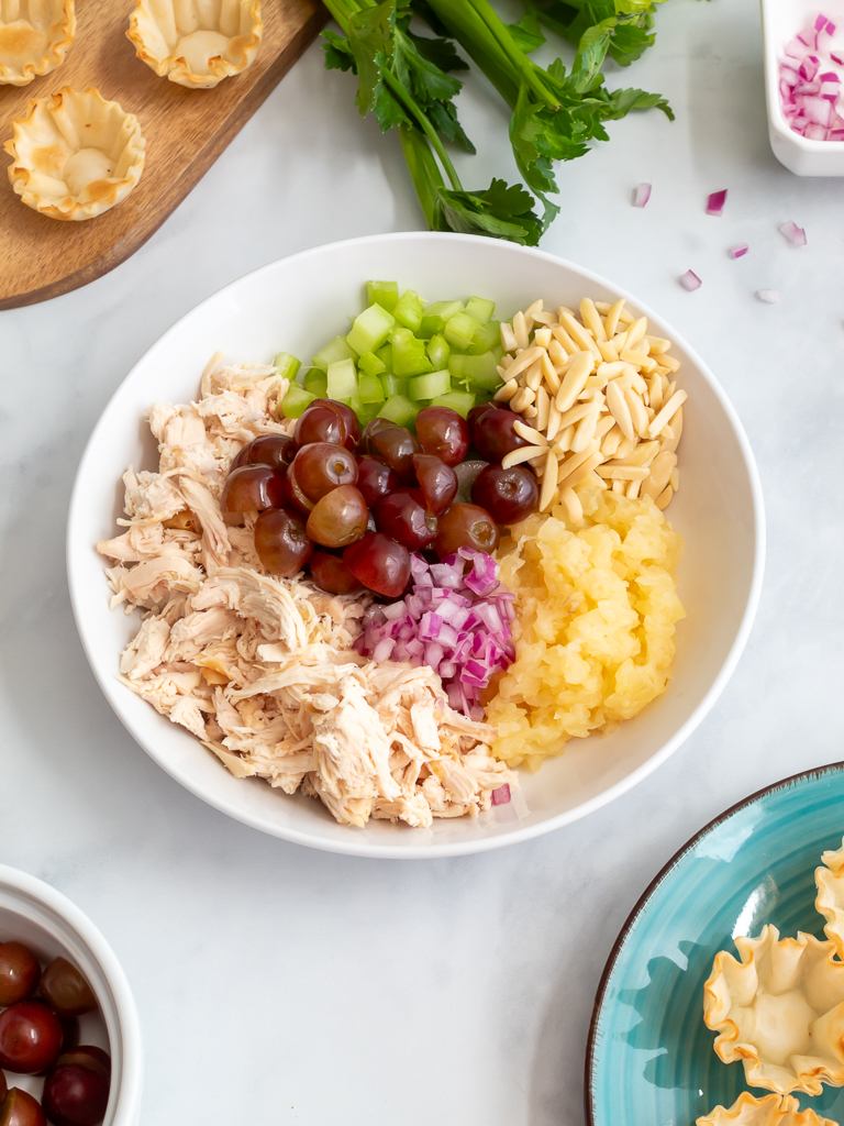 Ingredients In The Bowl For Pineapple Chicken Salad Appetizer with Grapes, Celery, and Almonds In Phyllo Cups - Midwest Life and Style Blog