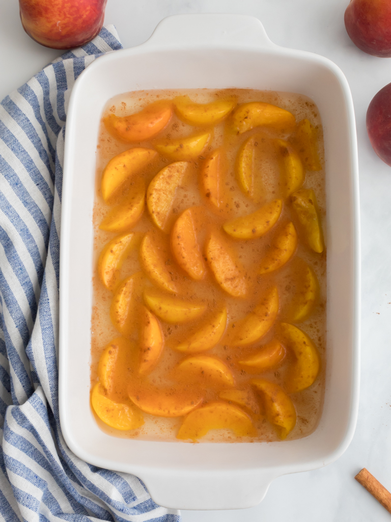 Laying Peaches in a Baking Dish for Dump Cake - Midwest Life and Style Blog