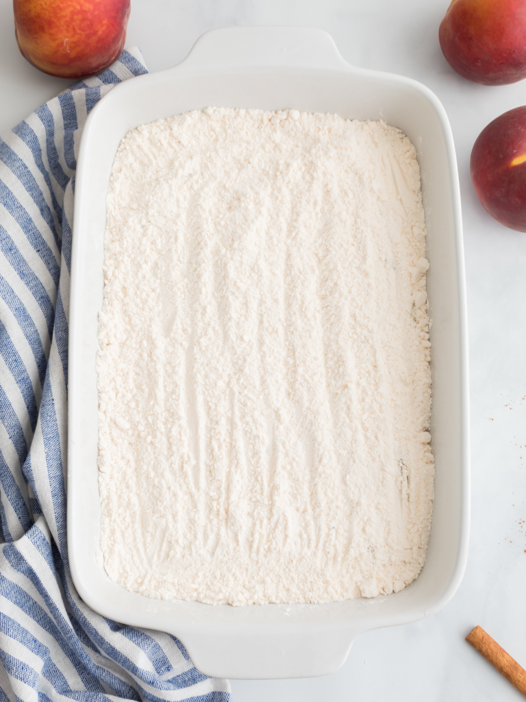 Adding Cake Mix on Top for Peach Dump Cake - Midwest Life and Style Blog