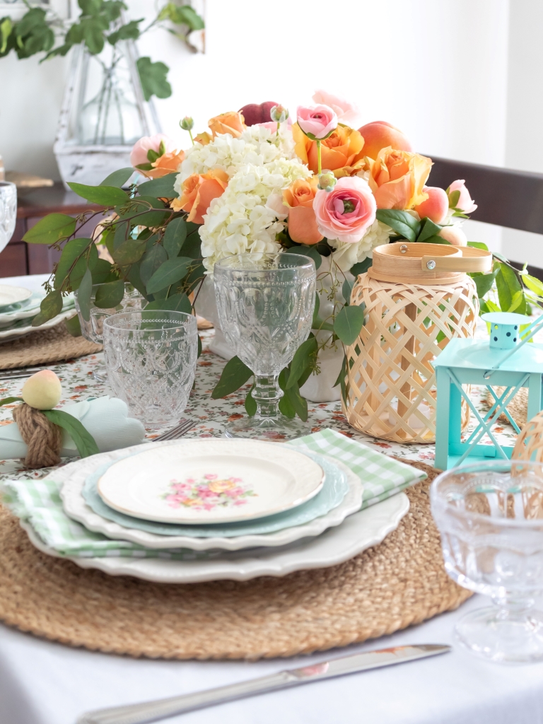 Peach-themed summer tablescape with hydrange and rose centerpiece with real peaches