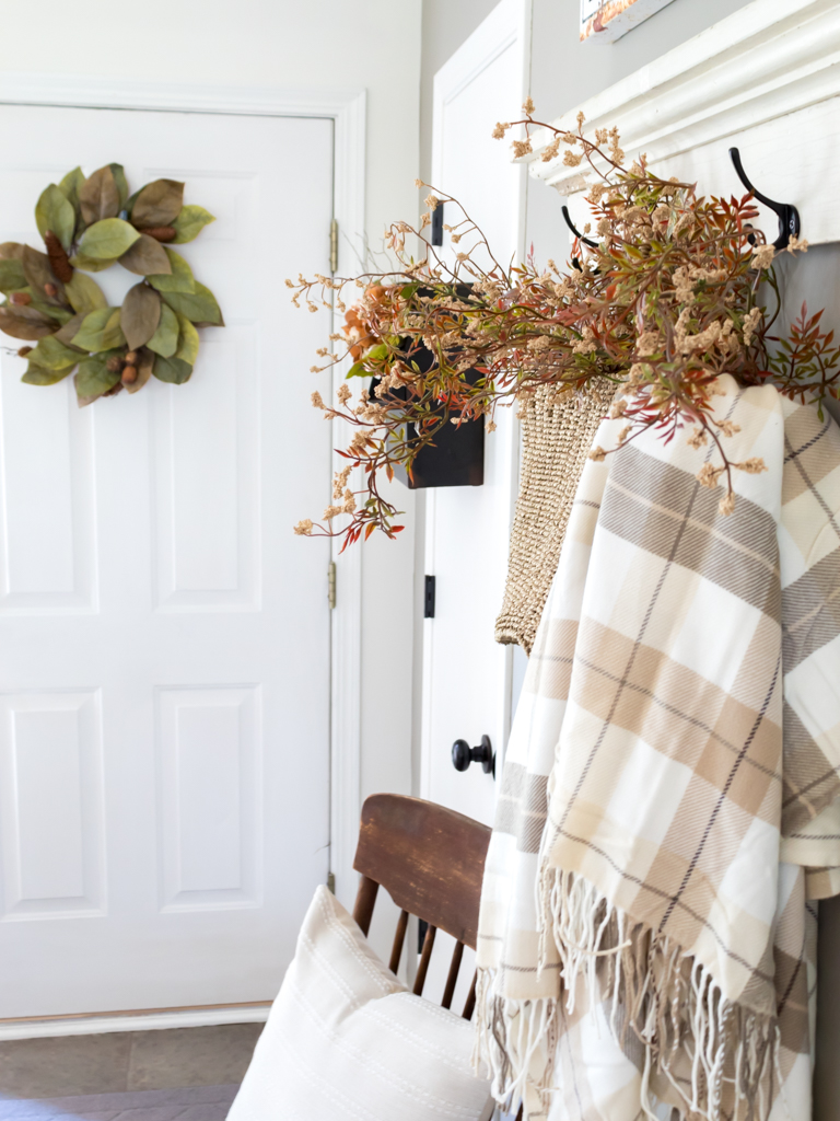 Hanging Straw Basket with Fall Florals and Plaid Blanket - Midwest Life and Style Blog