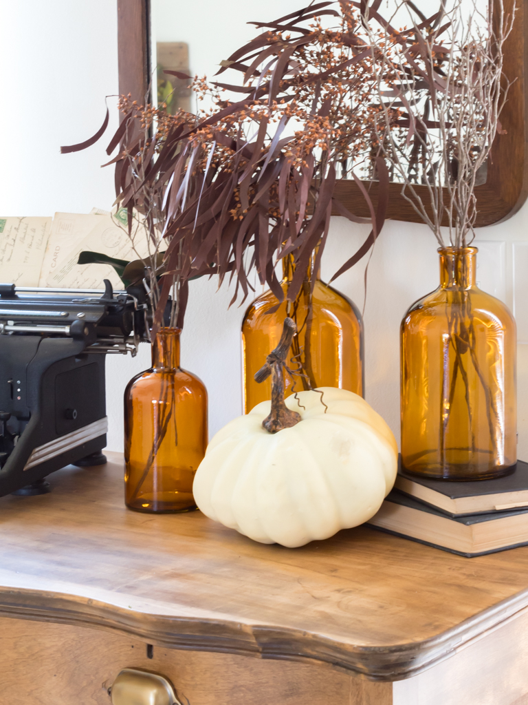 Amber Bottles with Fall foliage and White Pumpkins - Midwest Life and Style Blog