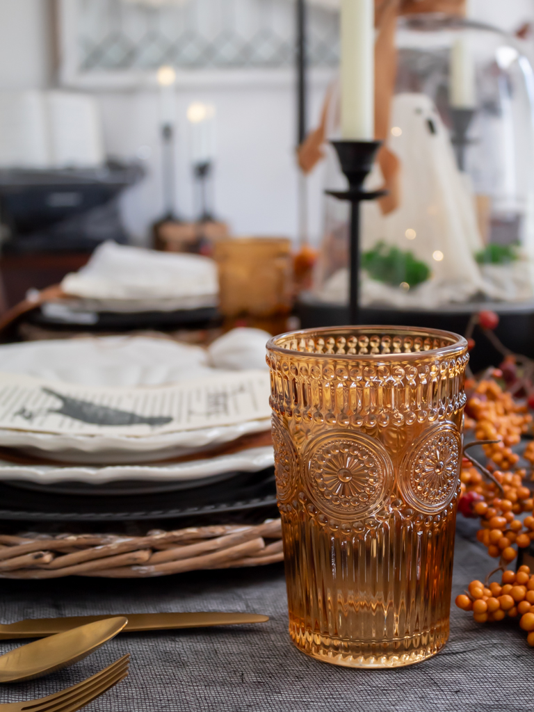 Vintage amber drinking glasses styled on a Halloween table