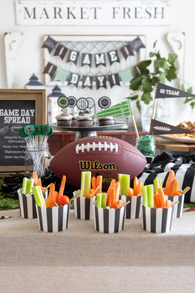 Dining Room styled with a free printable Super Bowl game day banner and foot-ball themed tablescape party with appetizers, a football cheese ball, and charcuterie cups withd dip for the Big Game.