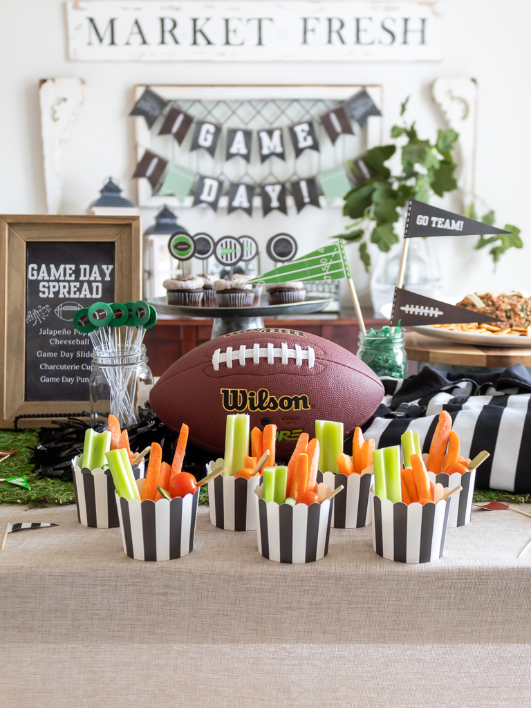 Dining Room styled with a free printable Super Bowl game day banner and foot-ball themed tablescape party with appetizers, a football cheese ball, and charcuterie cups withd dip for the Big Game.