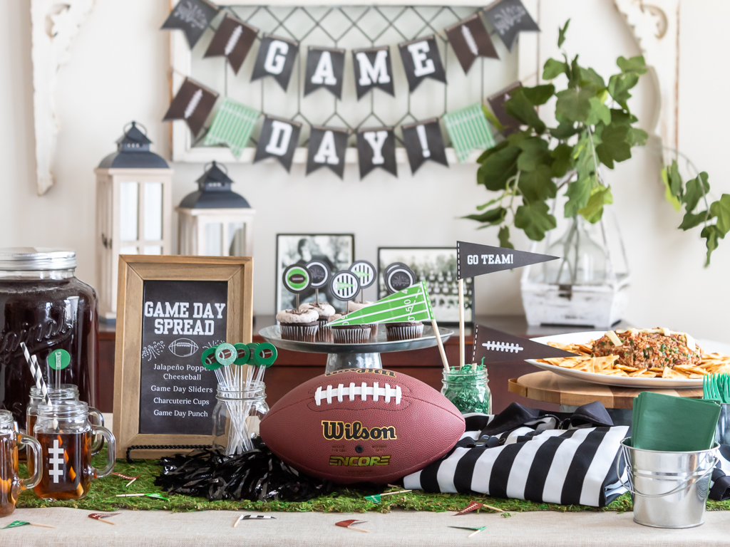 Green and black Super Bowl-themed tablescape with a  footbal and referee jersey centerpiece for a Big Game party