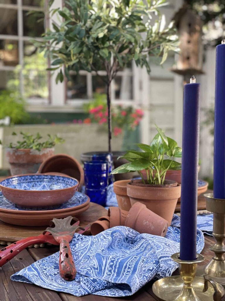 Weathered terracotta pots on a garden tablescape with old tools from WM Design House