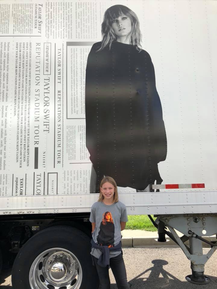 Standing outside the concert venue in front of the tour truck for the Reputation Tour