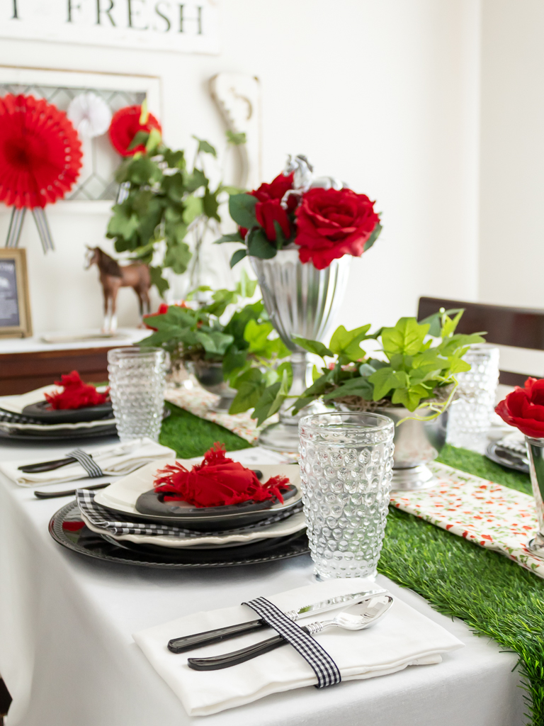 Ideas for setting a table for a Kentucky Derby party with red and black decorations and a DIY horse trophy centerpiece with red roses