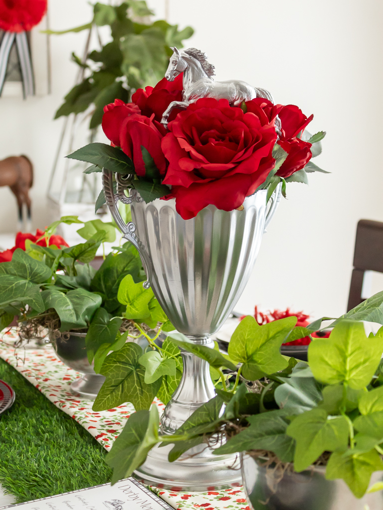 Upcycled trophy turned into a DIY horse trophy centerpiece with red roses for a Kentucky Derby tablescape and party