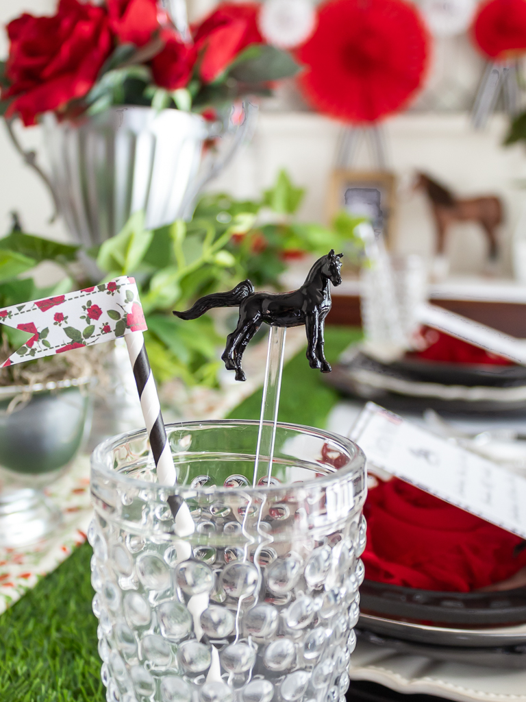 Close up of hobnail drinking glasses on a Kentucky Derby tablescape with straws and DIY horse stir sticks