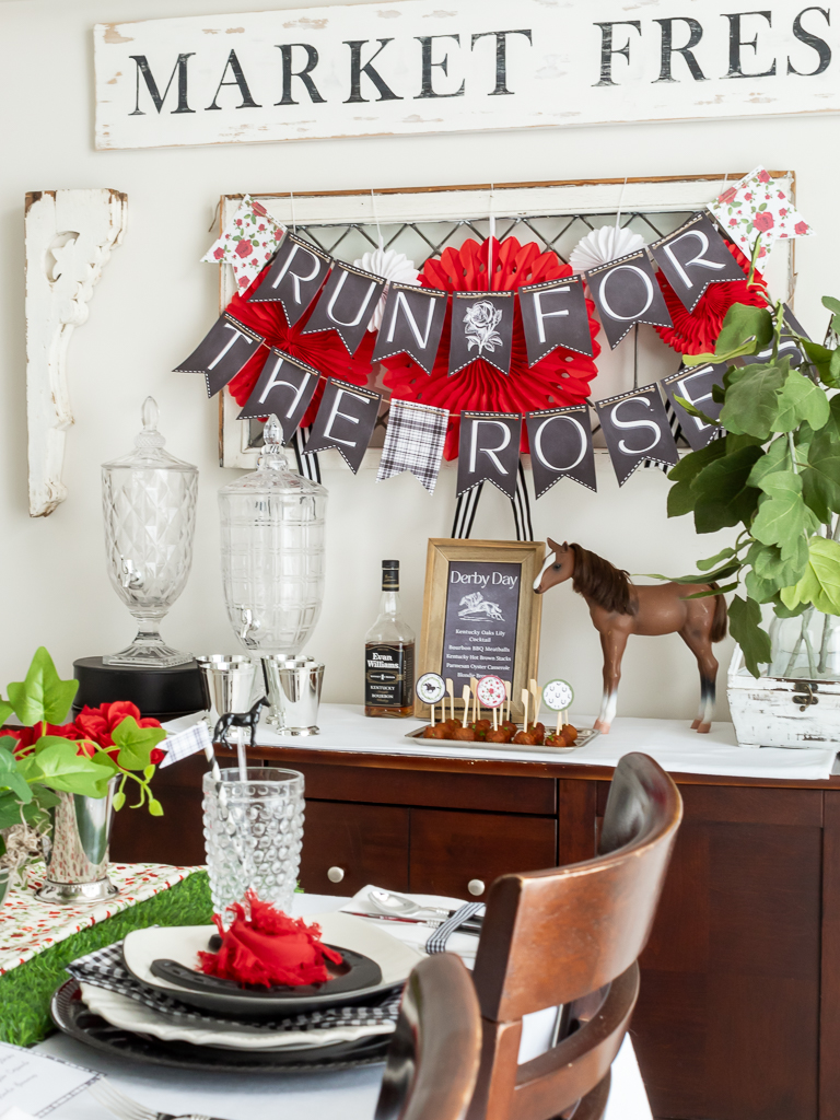 Buffett table set for a Kentucky Derby -themed Party with printable "Run for the Roses" banner hanging above it