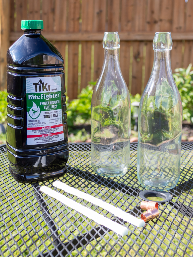 Citronella tiki torch fuel, glass bottles, and wicks to make DIY tiki torches 