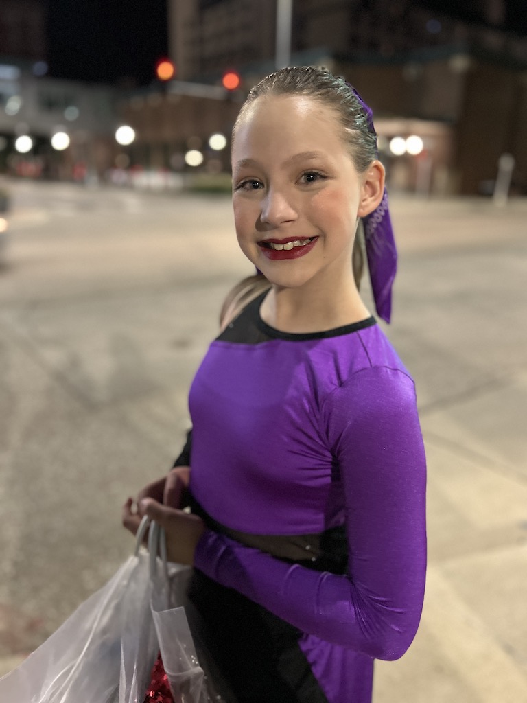 daugther smiling after dance recital peformance