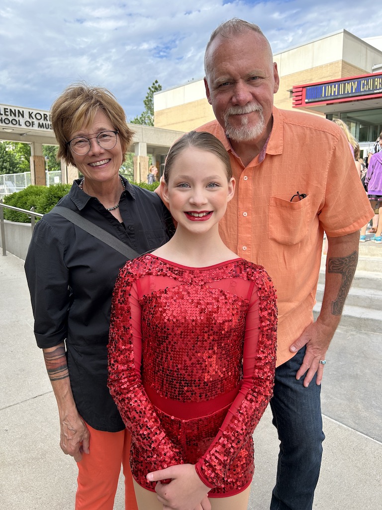 granddaugther with grandparents before dance recital