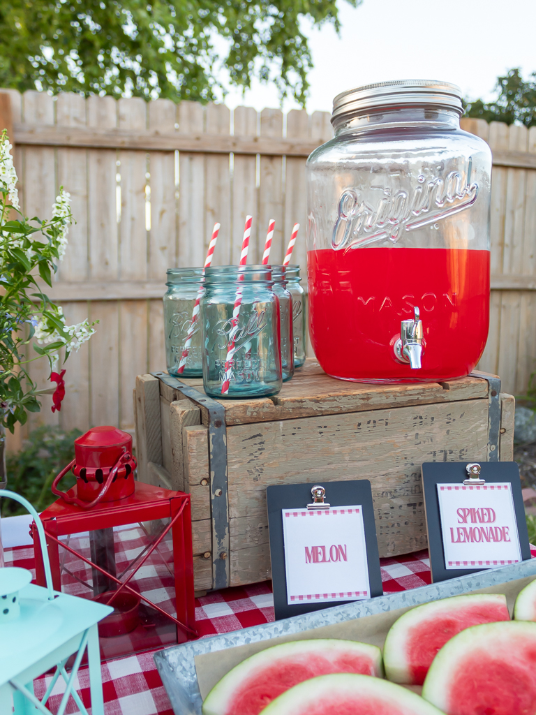 Gallon drink holder and blue ball glass drinking jars for a drink station at a backyard cookout 