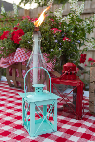 Close-up view of DIY glass bottle citronella tiki torch