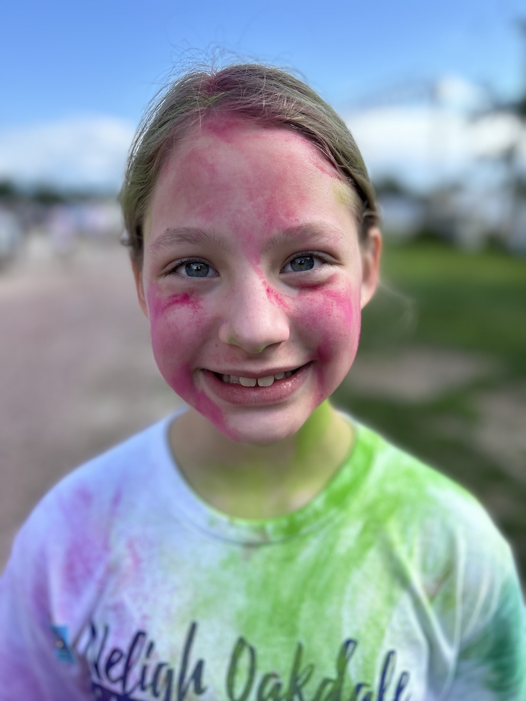 Smiling girl covered in paint after a color run