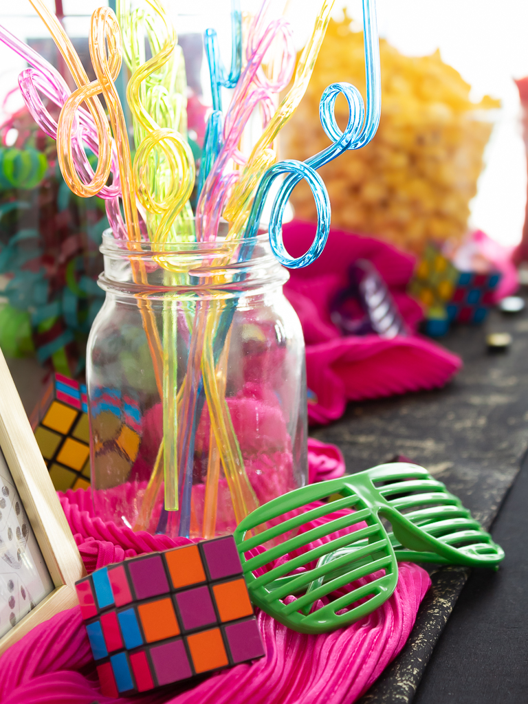 80s party decorations - crazys straws, sunglasses and Rubik's Cubes