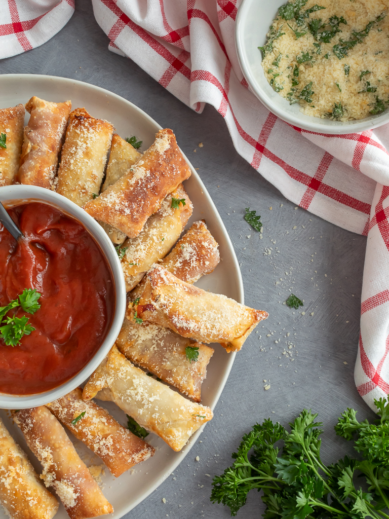 Homemade Pizza Rolls made in the Air Fryer displayed on a platter with pizza dipping sauce