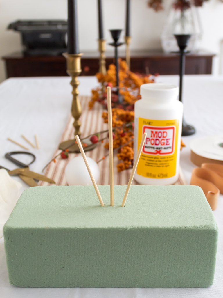 Foam brick with wood skewers to make DIY cheesecloth ghost