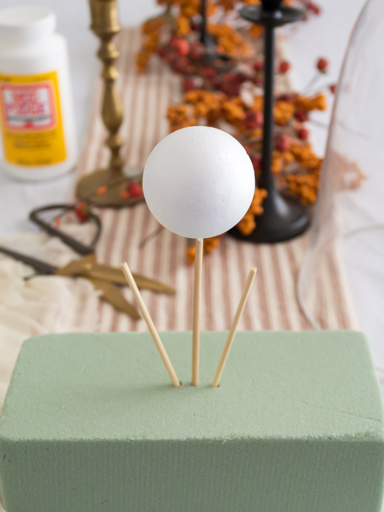 Foam brick with wood skewers and foaam ball to shape head to make DIY cheesecloth ghost