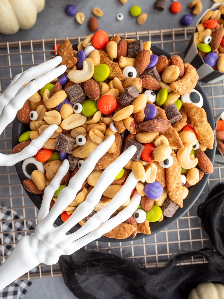 Overhead view of Halloween Monster Munch Trail Mix with skeleton hand serving utensils