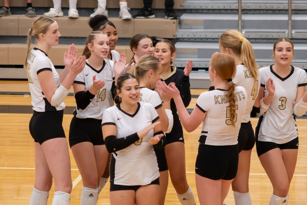 Volleyball team clapping and breaking from the team hudle before the game