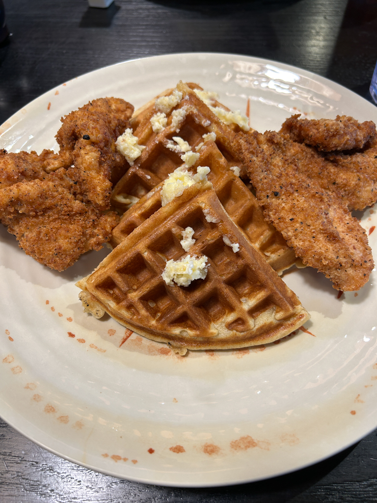 A plate of chicken and waffles for breakfast